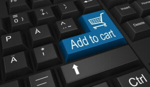 Tecla 'Add to Cart' en un teclado, simbolizando las innovaciones en ecommerce y compras en línea destacadas en las Noticias Shopping.